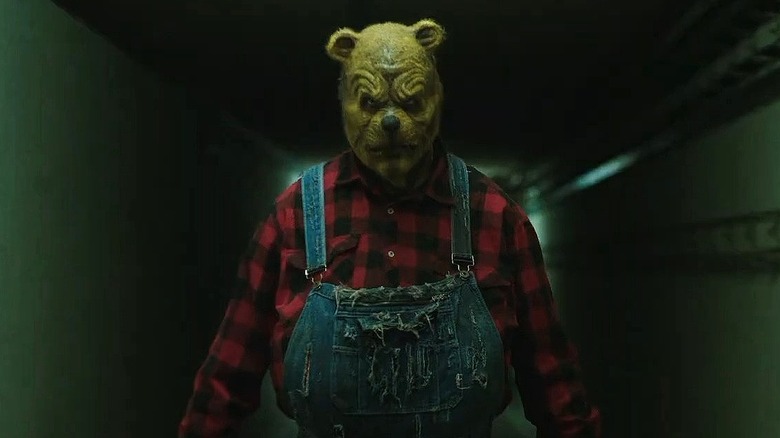 Winnie-the-Pooh staring at a bunch of scared ravers in Winnie-the-Pooh: Blood and Honey 2