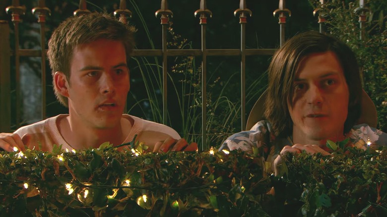 Eugene and Tucker hiding behind a bush in Miss March