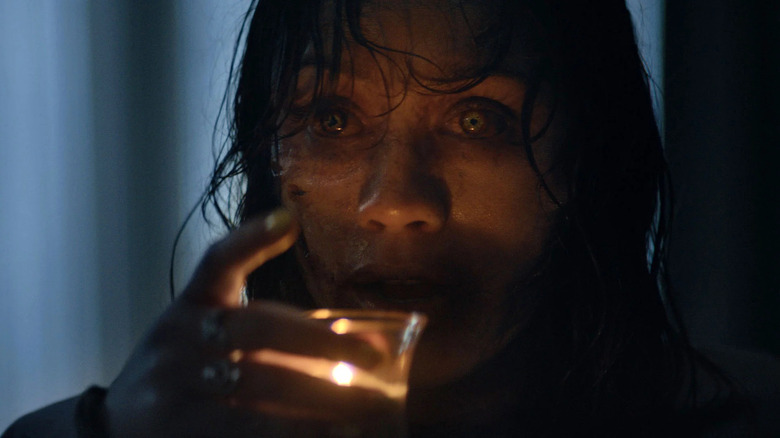 Deadite Thia drinking a candle in Evil Dead Burn (2026)