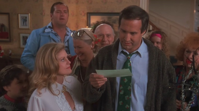 The Griswold family watching Clark open up Christmas bonus in National Lampoon's Christmas Vacation