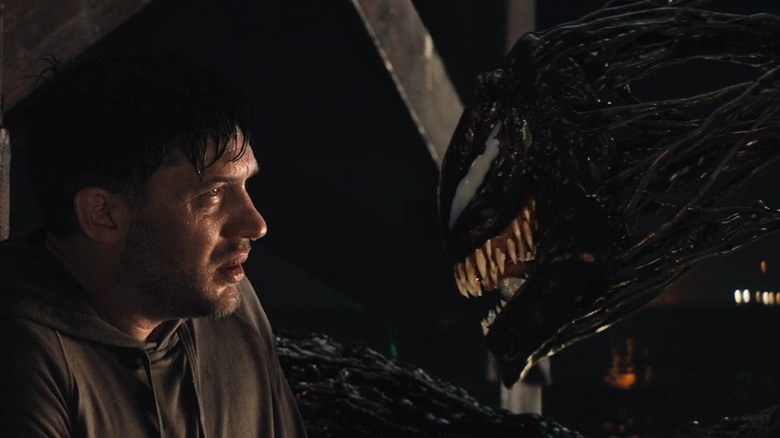 Eddie Brock looking at Symbiote Venom in Venom