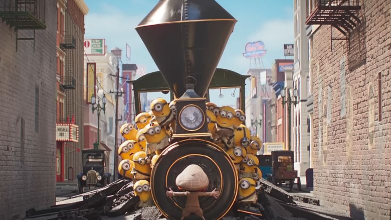 The minions in a train with a director in front of it in Minions & Monsters