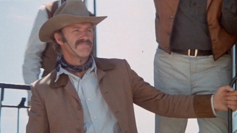 Brandt Ruger riding on a train car in "The Hunting Party" (1971)