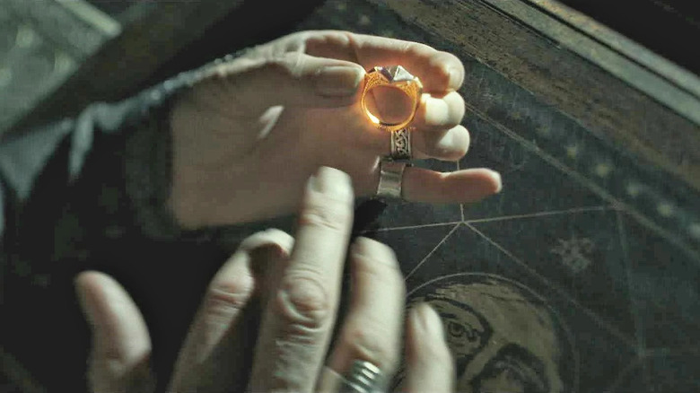 Dumbledore's hand putting on Marvolo Gaunt's ring in Harry Potter and the Half-Blood Prince