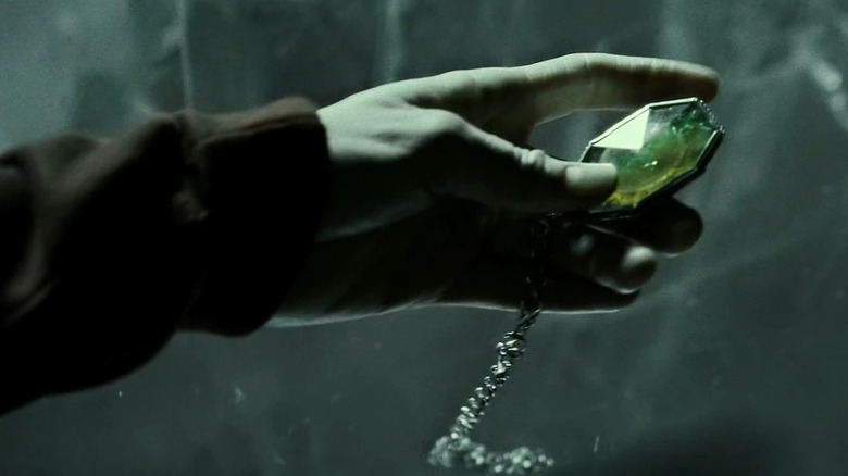 Hand holding Slytherin's locket in Harry Potter and the Half-Blood Prince