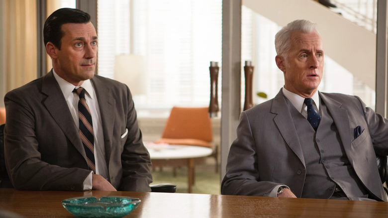 Don and Roger at a conference room table looking confused on "Mad Men" (2007-2015)