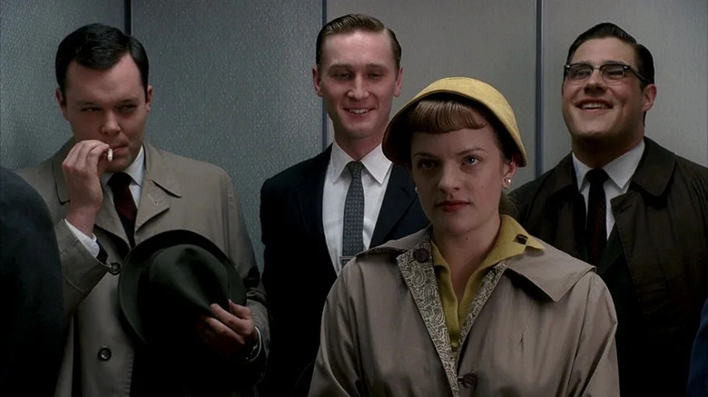 Paul Ken and Harry looking at Peggy in the elevator on "Mad Men"