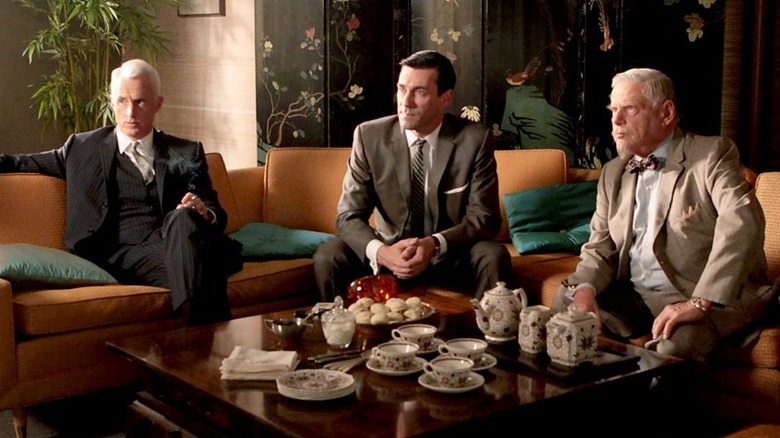 Roger, Don, and Bert sitting in a hotel room in "Mad Men"