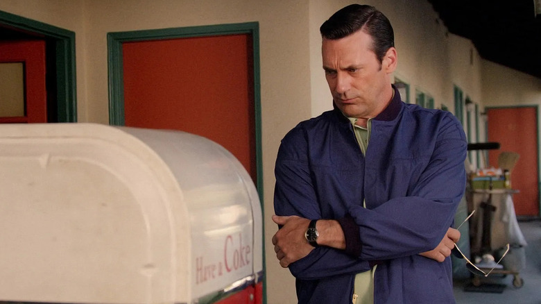 Don thoughtfully looking at a Coke machine on "Mad Men"