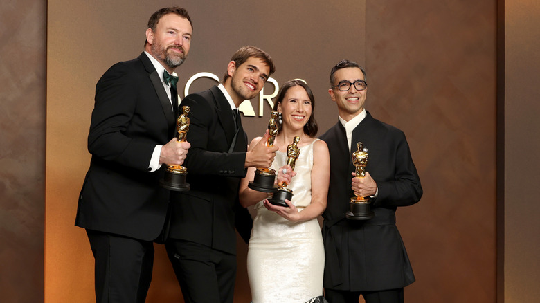 Jack Piatt, Sam A. Davis, Natalie Musteata, and Alexandre Singh pose with their Oscars