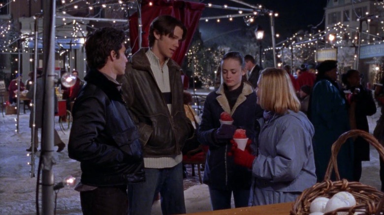Jess Dean Rory and Clara outside talking at the Winter Carnival on Gilmore Girls