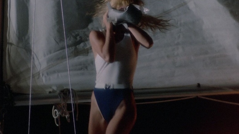 A flying piranha attacking a beach babe in Piranha II: The Spawning