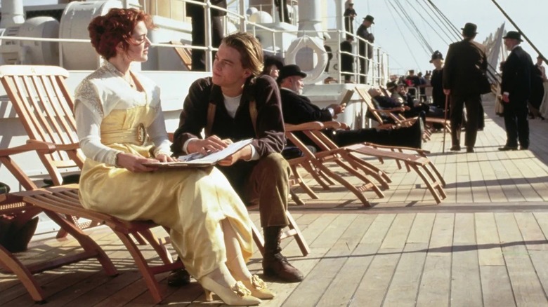 Rose and Jack sitting on the Titanic's deck in Titanic (1997)