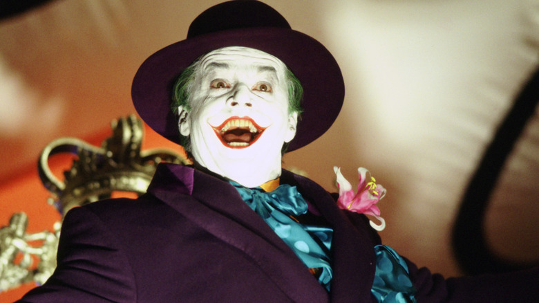 The Joker grinning during a parade in "Batman"
