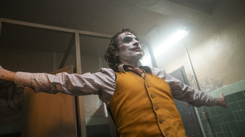 Arthur extending his arms in a bathroom in "Joker"