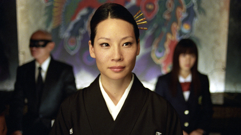 O-Ren Oshii sititng in front of Gogo and Johnny in Kill Bill (2003)
