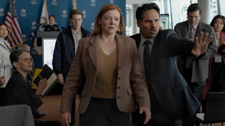 Marissa walking out of a press conference with Jim yelling at the press on All Her Fault