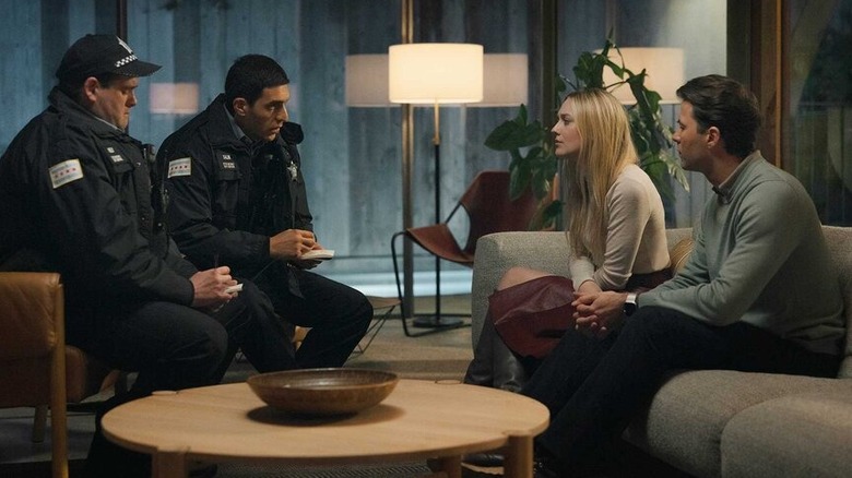 Police talking to Jenny and Richie in their living room in All Her Fault