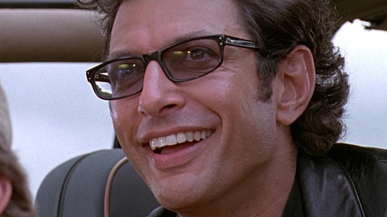 Ian Malcolm smiling in a car