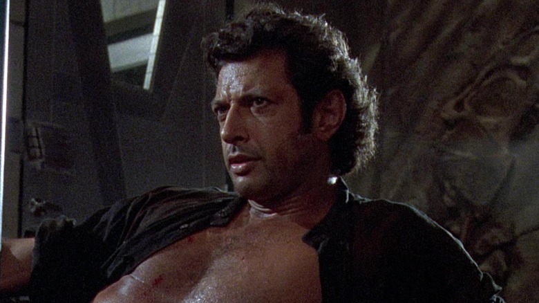 Ian wounded in an open black shirt