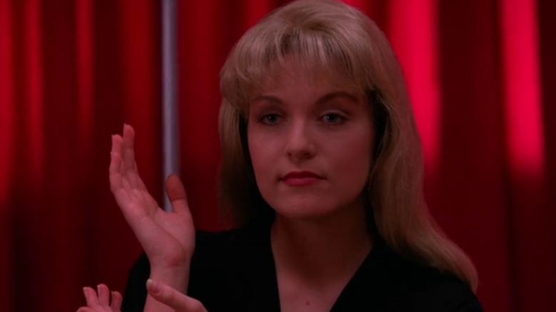 Laura Palmer surrounded by red curtains