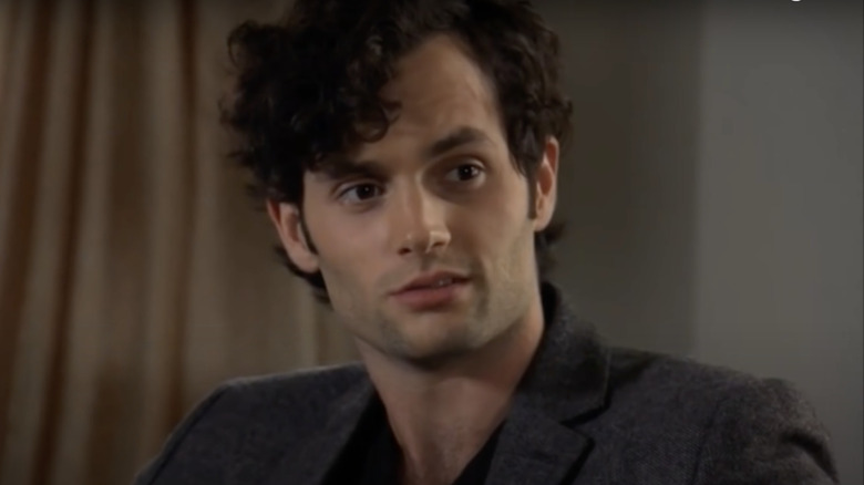 Dan smirking wearing suit