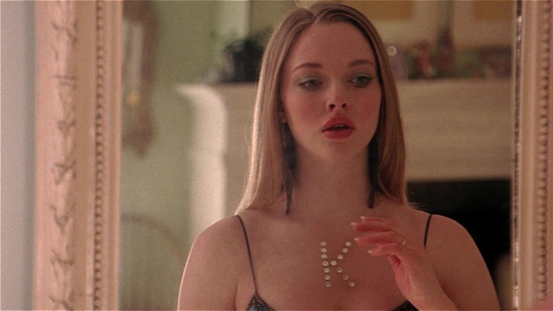 Karen putting a bejeweled K on her chest in Mean Girls