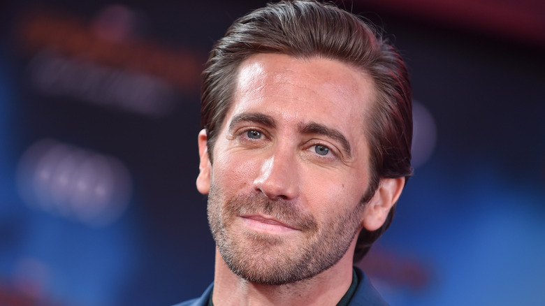 Jake Gyllenhaal posing with blue background