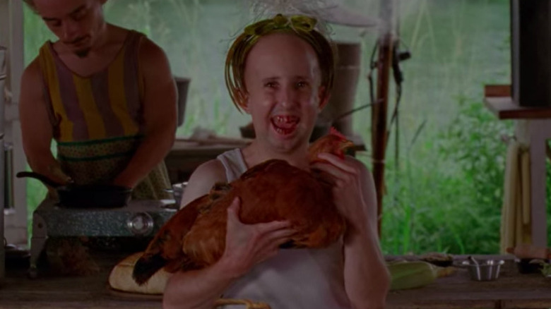 Meep holding a chicken in "Freak Show"