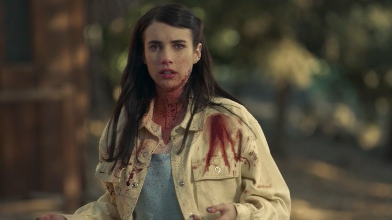 Brooke standing covered in blood 