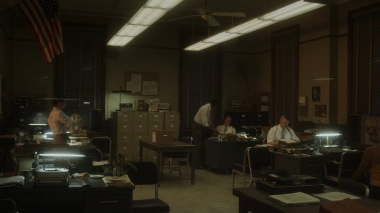 Patrick sits at his desk
