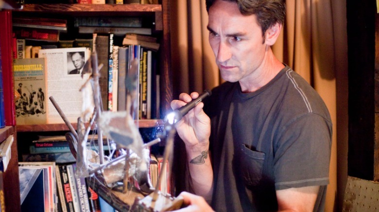 Mike Wolfe holding a flashlight