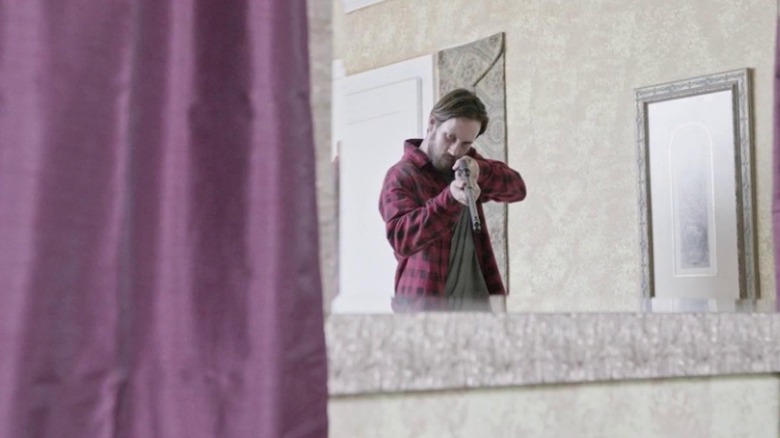 Butch DeFeo pointing a gun