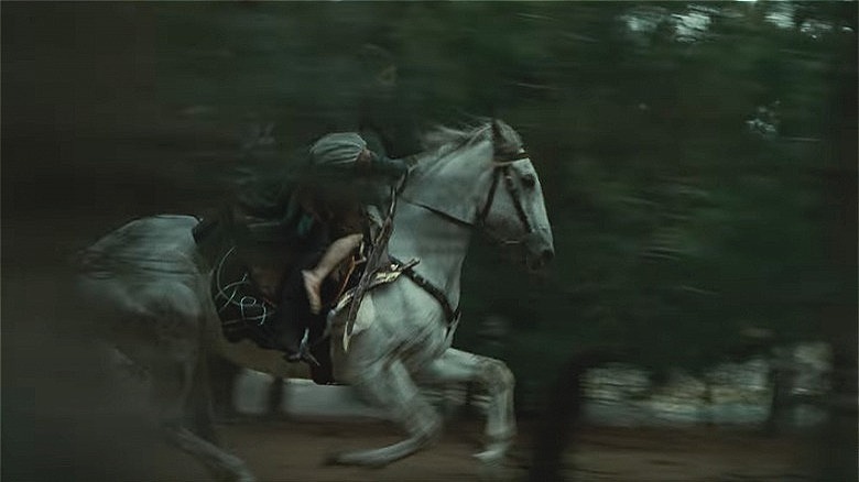 Arwen rides Asfaloth through trees