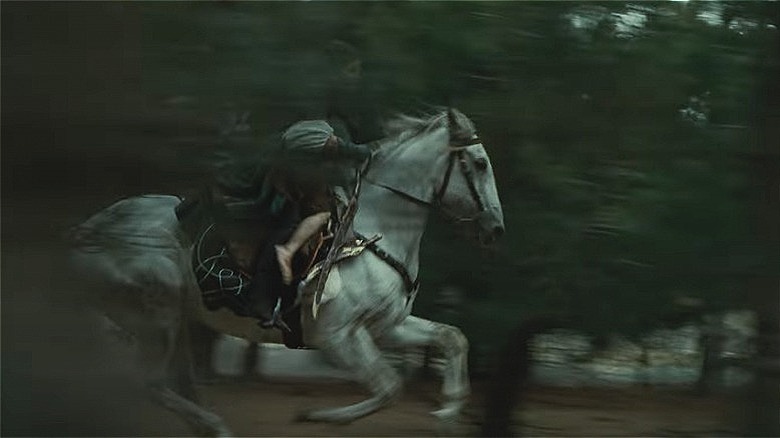 Arwen rides Asfaloth through trees