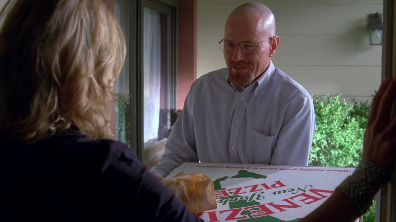 Walter White from "Breaking Bad" Season 3 standing at the door holding a pizza for Skylar