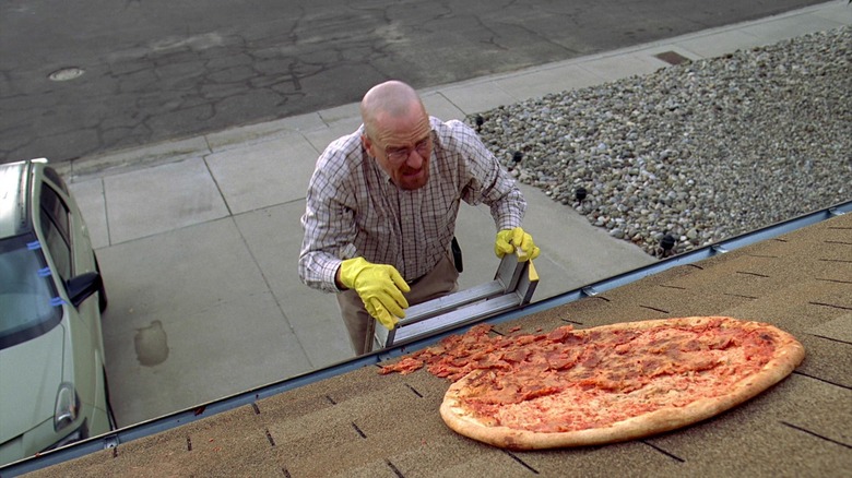 Walter White from "Breaking Bad" Season 3 cleaning a pizza off the roof
