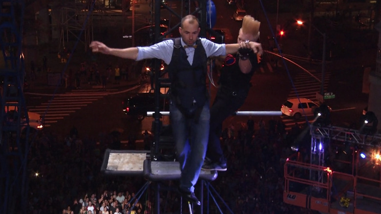James Murray walking on a tightrope