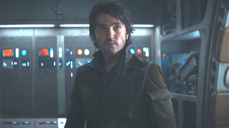 Cassian standing in a ship 