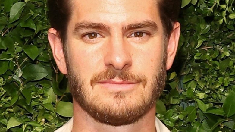 Andrew Garfield in front of greenery