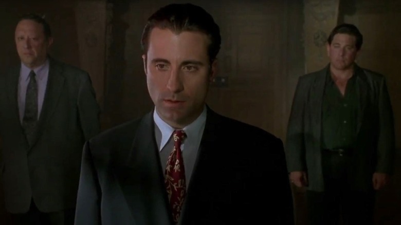 Jimmy Tosnia flanked by gangsters