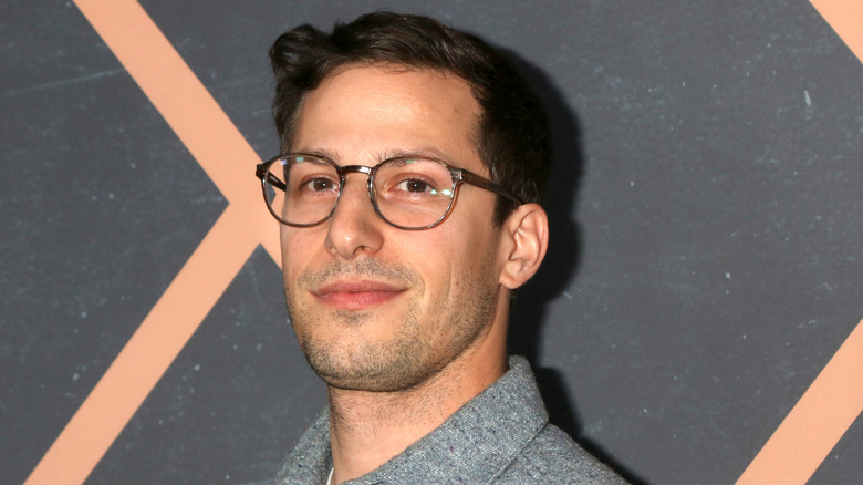 Andy Samberg smiling at event