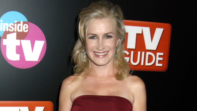 Angela Kinsey smiling in red dress