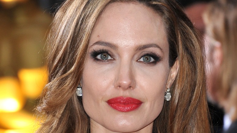 Angelina Jolie looking at camera wearing earrings