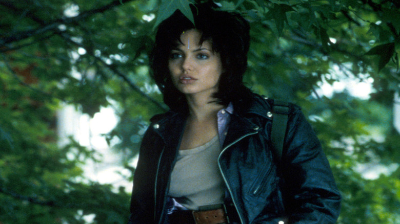 Angelina Jolie as Gia looks off to side under tree