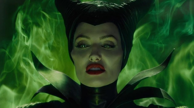 Maleficent with green smoke behind her