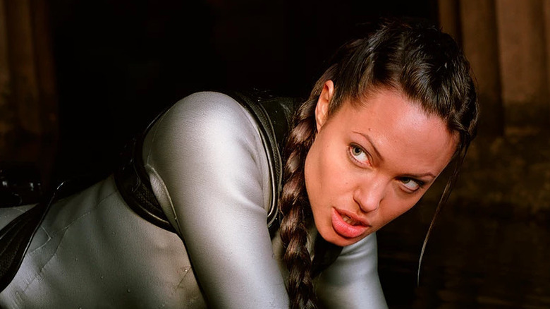 Angelina Jolie looks off to side from the ground