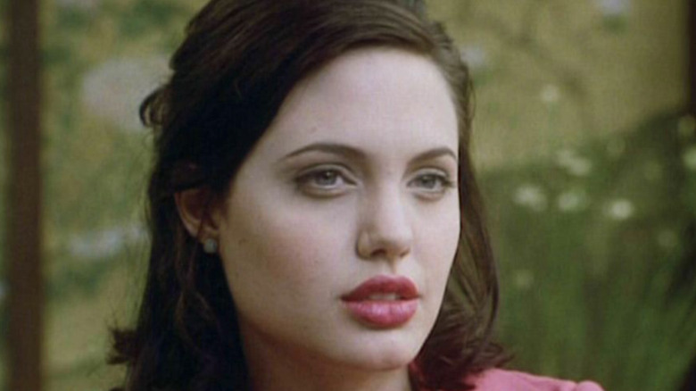 Angelina Jolie looks off to side with lips parted