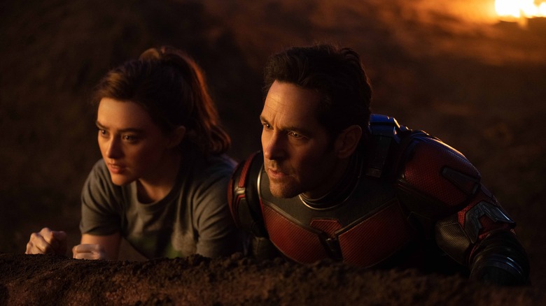 Scott and Cassandra Lang hiding behind a rock