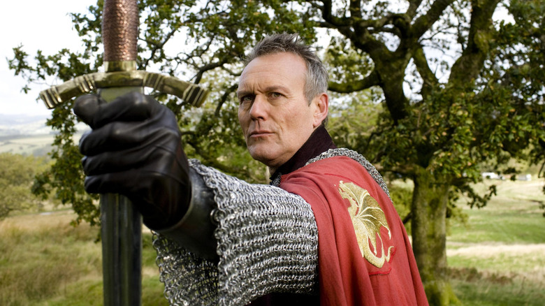 Uther brandishes his sword in "Merlin" (2008-2012)